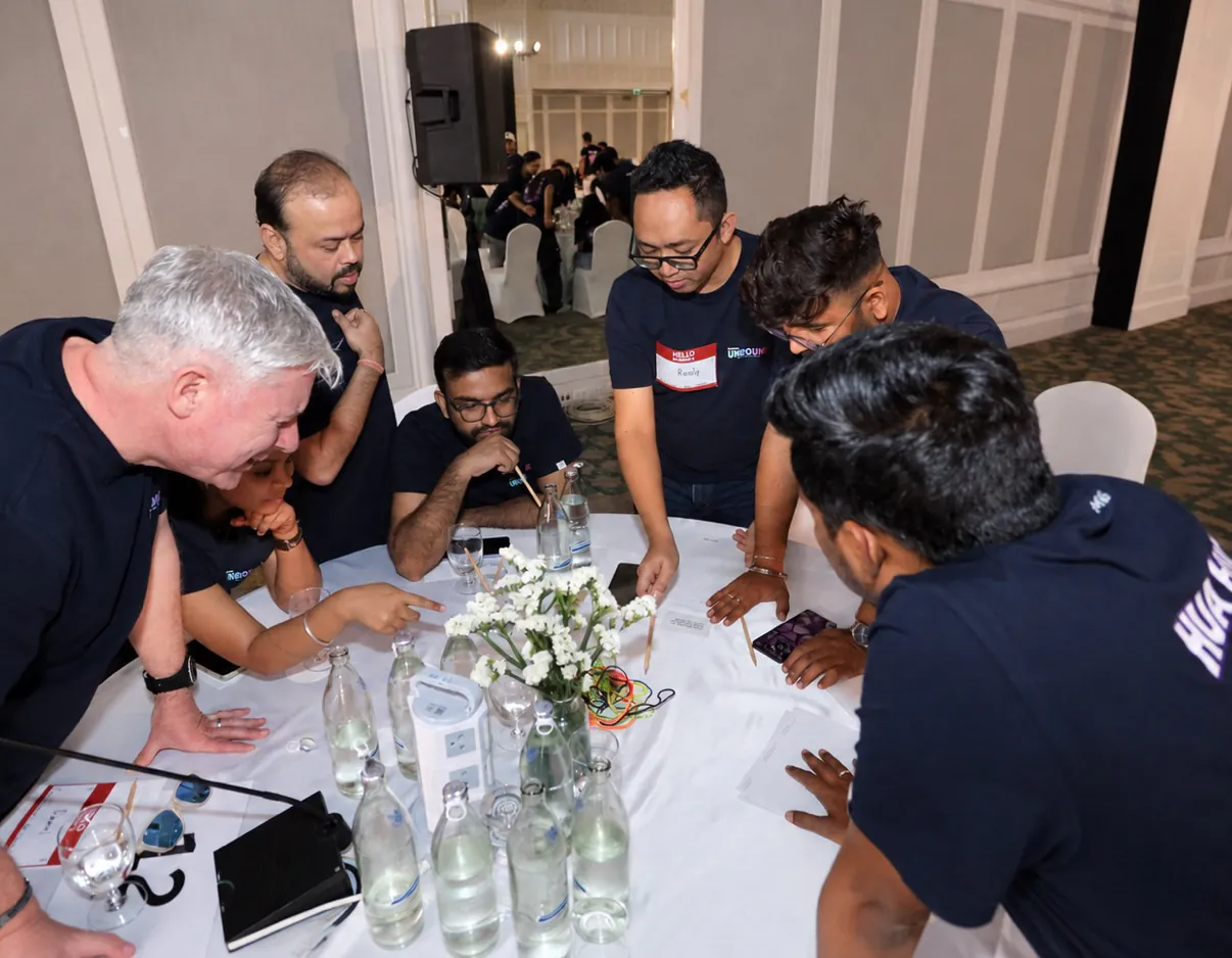 Locus team members collaborating around a table at a team workshop