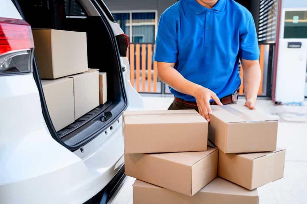 Delivery worker unloading packages from a van.
