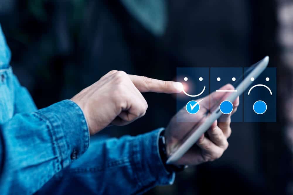 Customer giving positive feedback on a digital satisfaction survey using a tablet