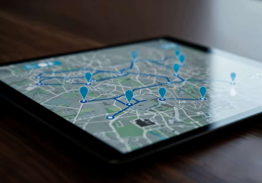 Digital tablet showing a mapped delivery route with multiple pins.