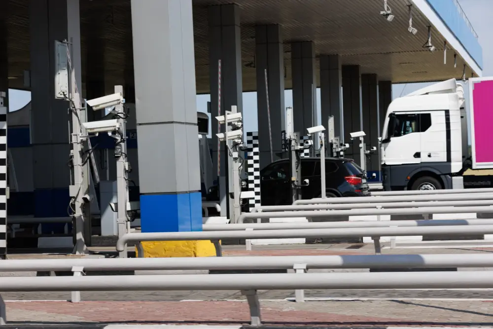 Trucks and cars at a border checkpoint with automated surveillance systems