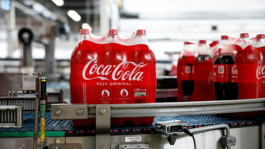 Coca-Cola bottles moving on a conveyor belt during Direct Store Delivery packaging process