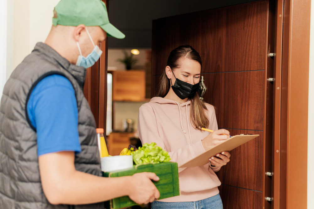 Delivery executive handing over a food order at a restaurant pickup point