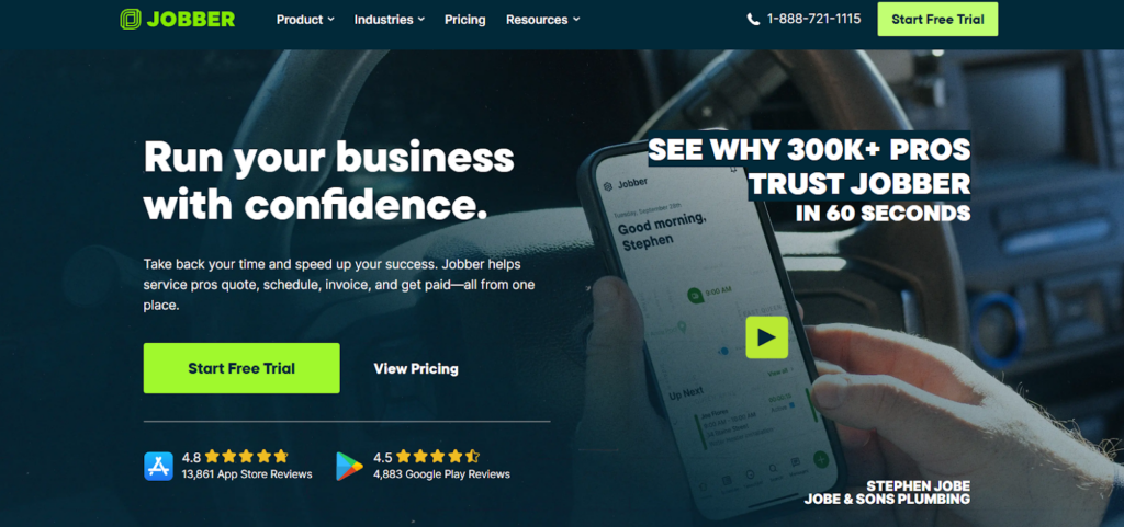 Jobber website homepage showing a hand holding a smartphone